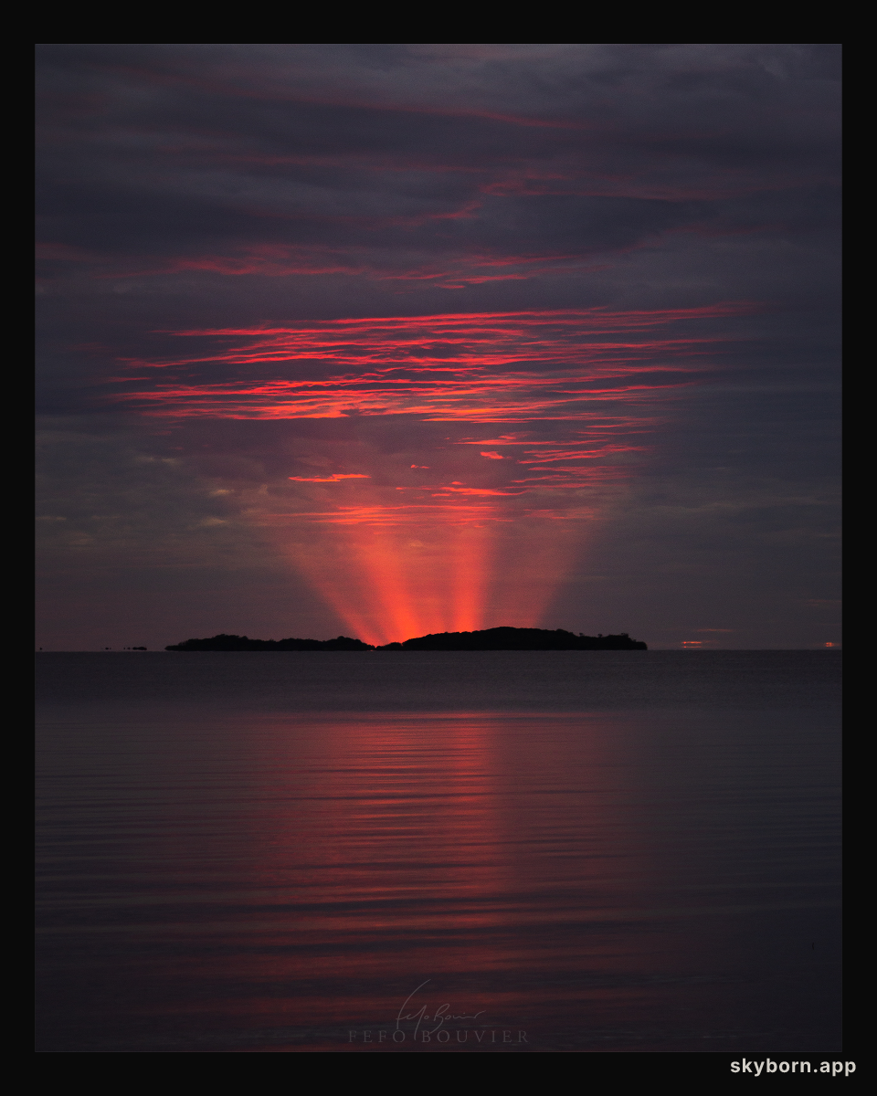 Red Crepuscular Rays from an Eclipse