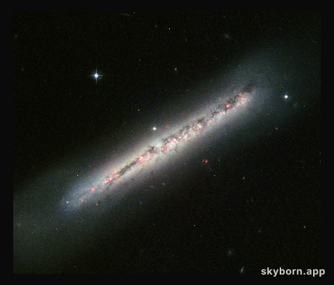 Glowing gas and dark dust in a side-on spiral