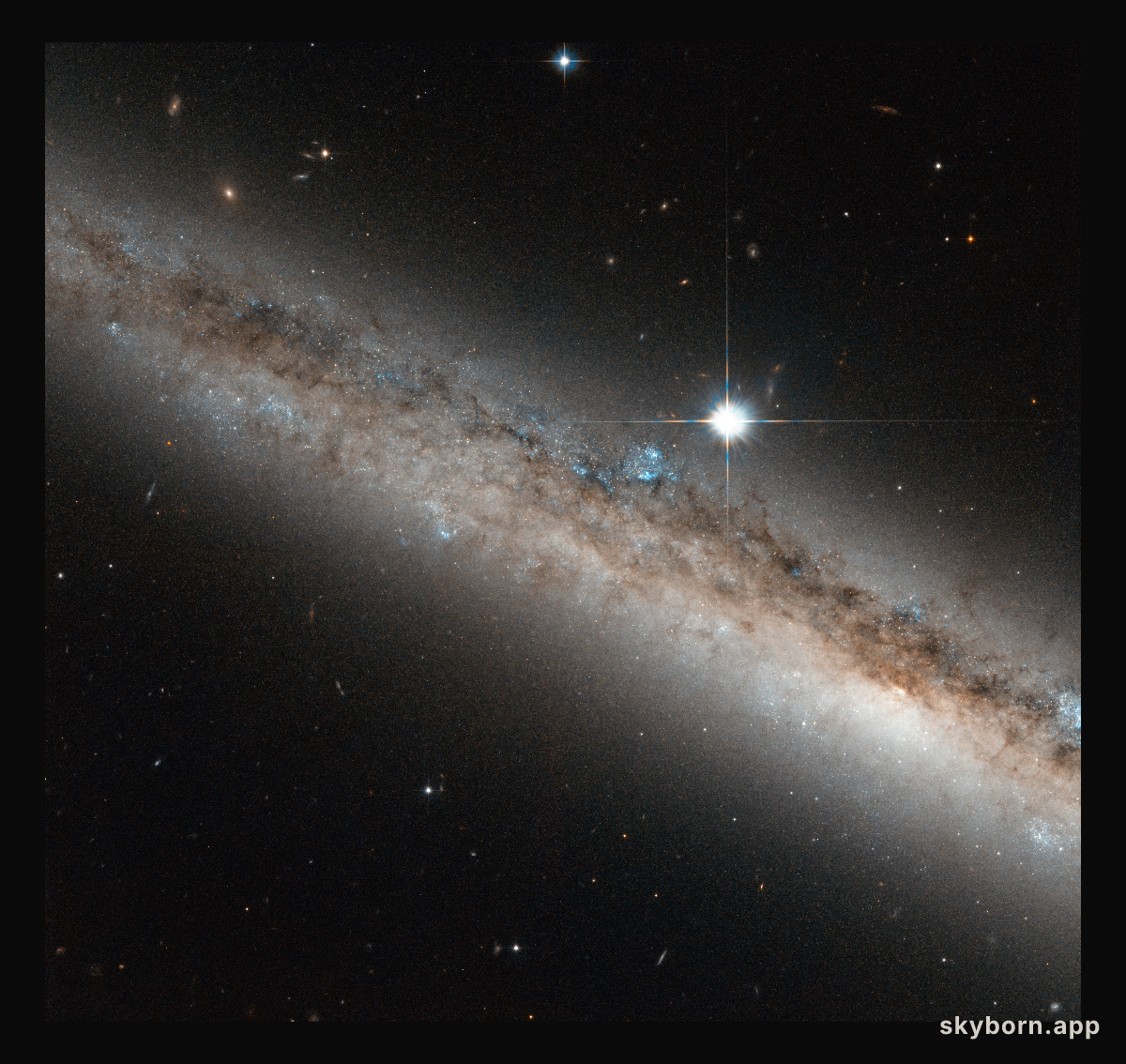 A spiral galaxy crowned by a star