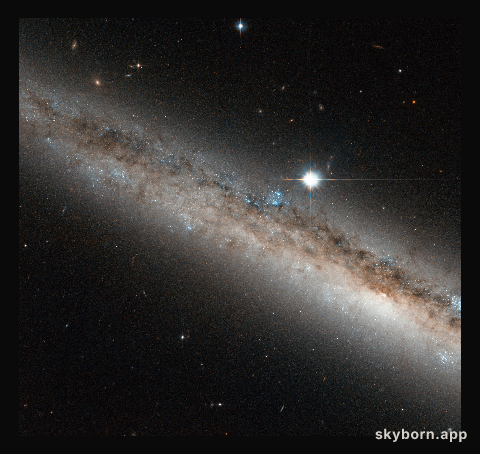 A spiral galaxy crowned by a star