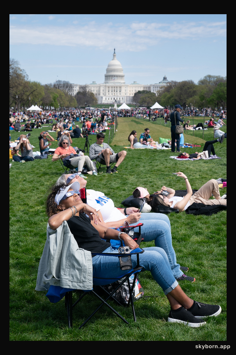Patricia Jones (front) and Renee Chapman view a partial solar eclipse in Washington, DC, Monday, April 8, 2024