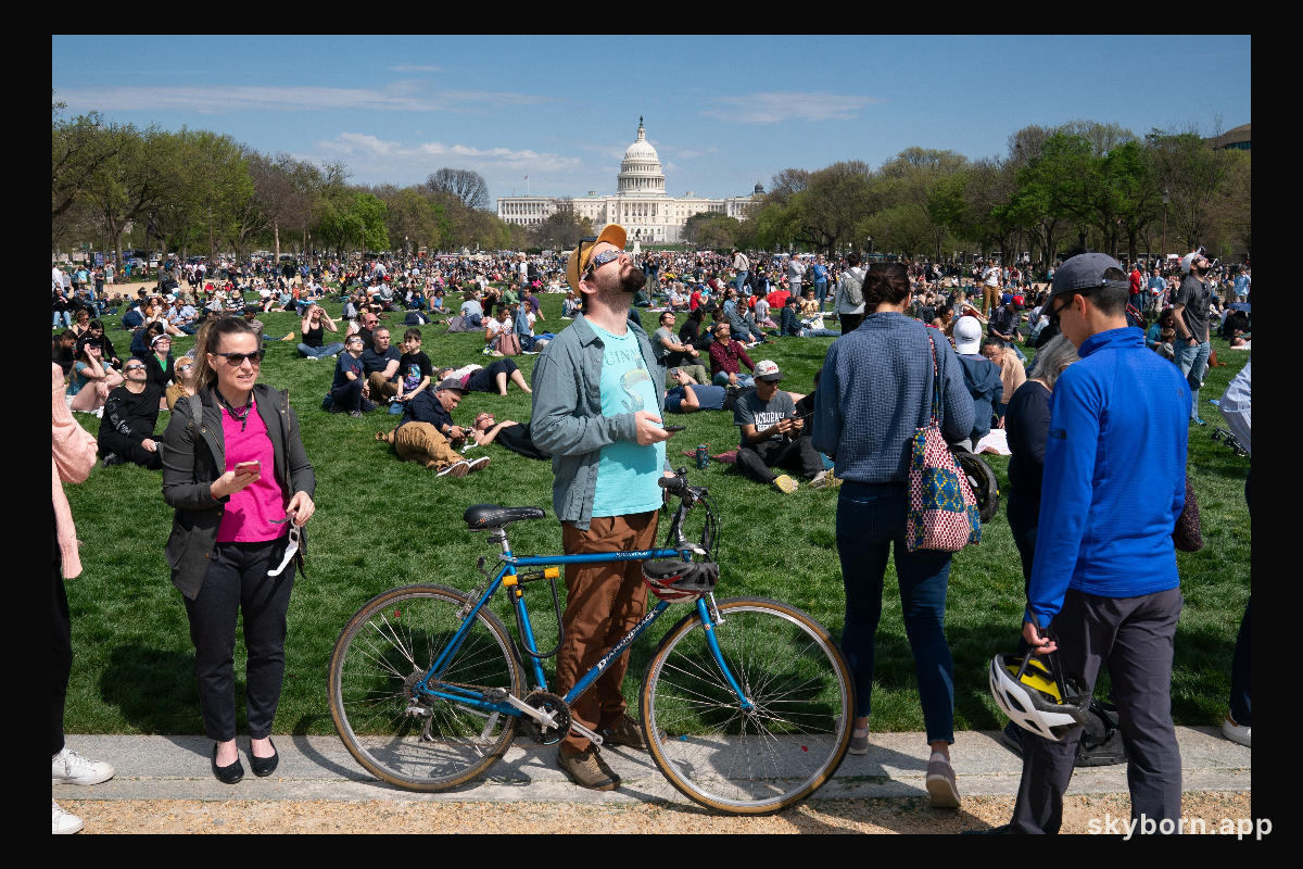 Mike Tyska (center) views a partial solar eclipse in Washington, DC, Monday, April 8, 2024