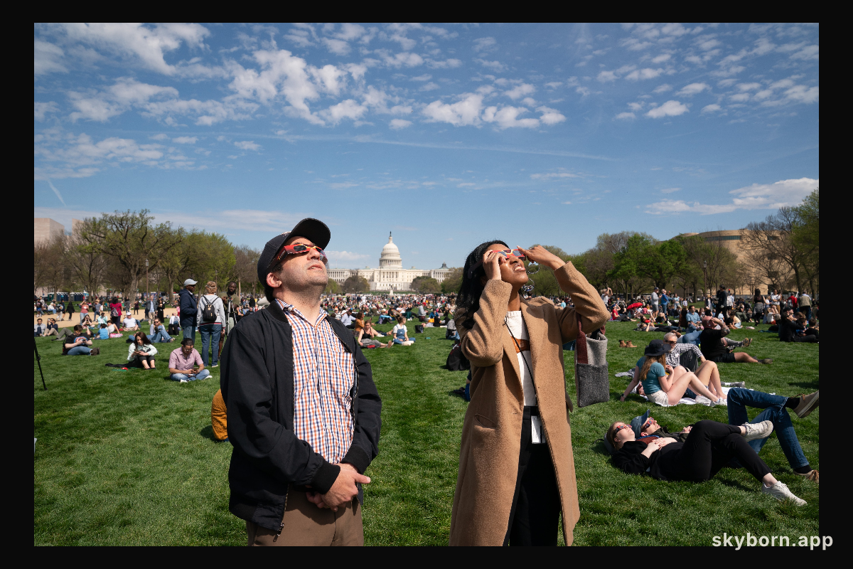 Brian Wolly and Kayla Randall view a partial solar eclipse in Washington, DC, Monday, April 8, 2024