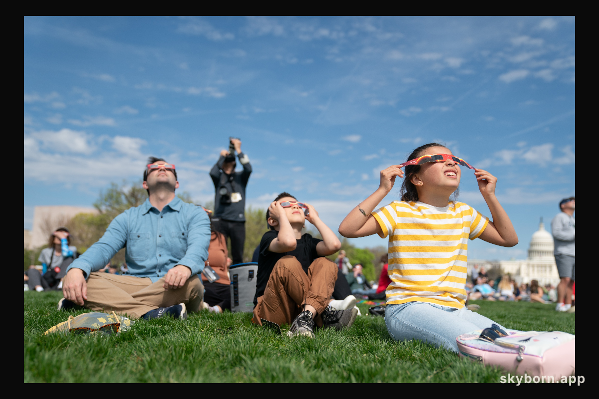 and Cameron (center), with their father Cameron Dyal view a partial solar eclipse in Washington, DC, Monday, April 8