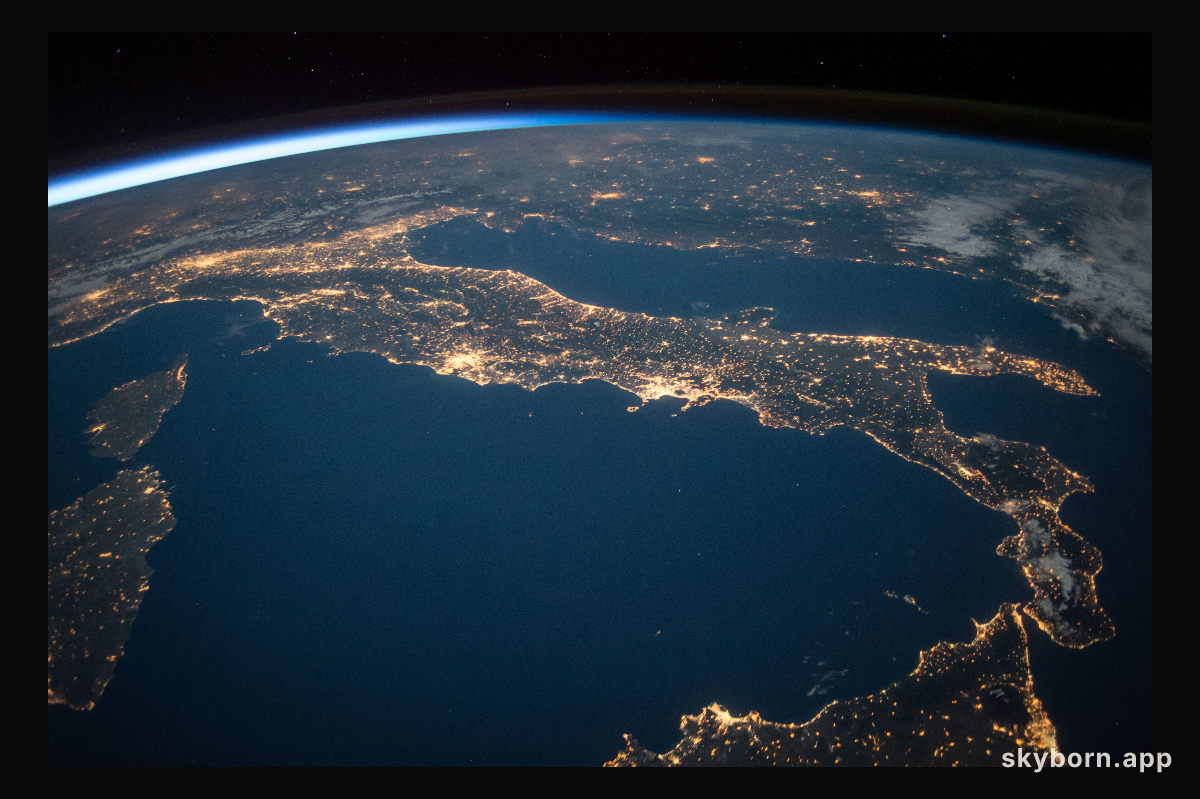 The familiar "boot" shape of the county of Italy stands out in this nighttime image with sparkling city lights reaching