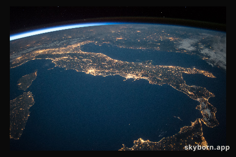 The familiar "boot" shape of the county of Italy stands out in this nighttime image with sparkling city lights reaching