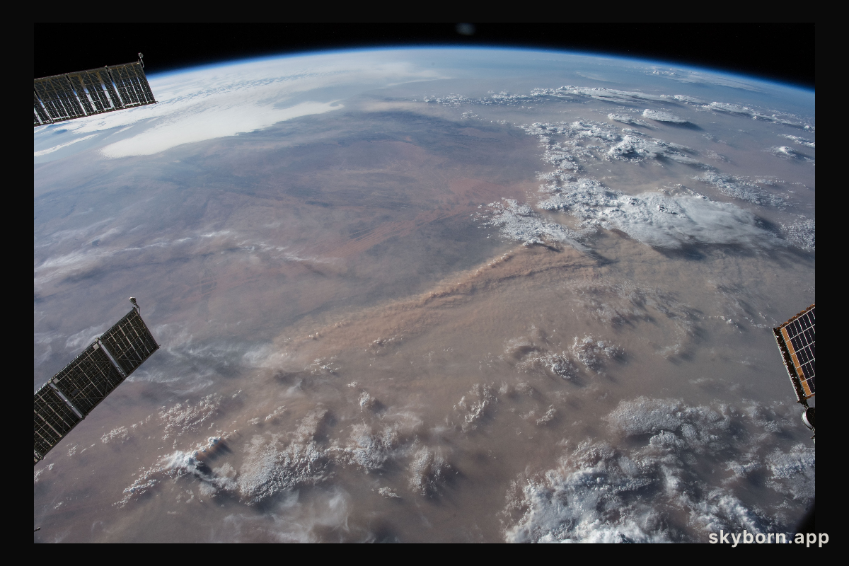 Earth's limb and dust storms in the Sahara are pictured as the International Space Station orbited nearly 252 miles