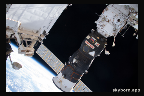A waning crescent moon is barely visible in the center background as the International Spacer Station orbited 262 miles