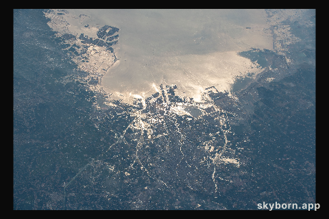 The northeastern Chinese port city of Tianjin is pictured with the Sun's glint beaming off the Bohai Sea