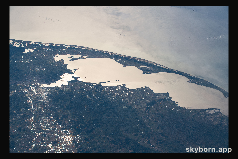 The Sun's glint beaming off Brazil's largest lagoon, Lagos dos Patos, on the nation's southernmost tip is pictured