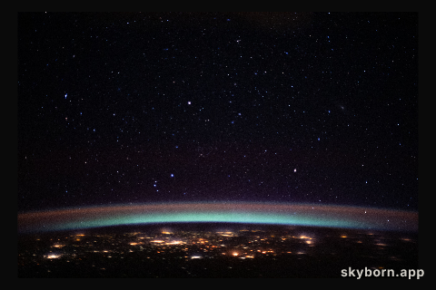 The city lights at the intersection of Europe and Asia sparkle underneath an atmospheric glow and a starry night sky