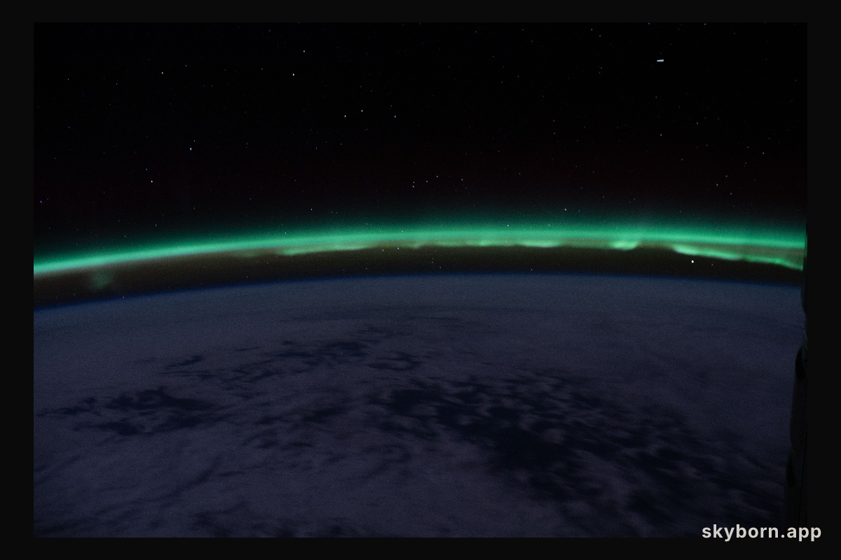 The "aurora australis" hovers above the Earth's horizon as the International Space Station nears the southern-most