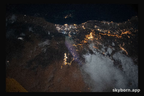 The city lights of Jazan (top center) and its suburbs on the Persian Gulf coast of Saudi Arabia are easily visible