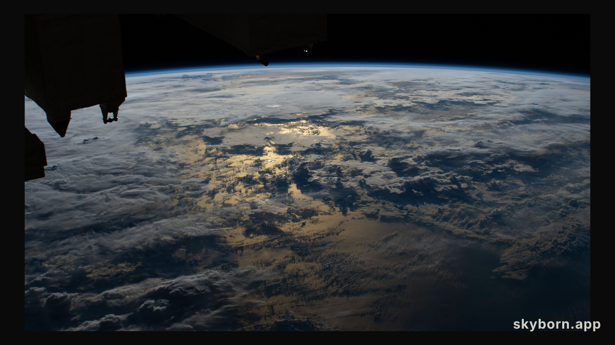 The sun's glint on the Timor Sea between Indonesia and Australia is mellowed by cloud cover in this photograph