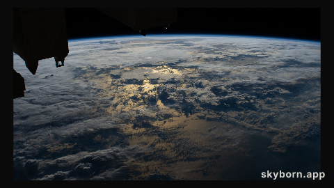 The sun's glint on the Timor Sea between Indonesia and Australia is mellowed by cloud cover in this photograph