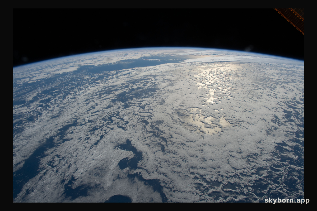 The sun's glint beams on the South Pacific Ocean as the International Space Station orbited just off the coast