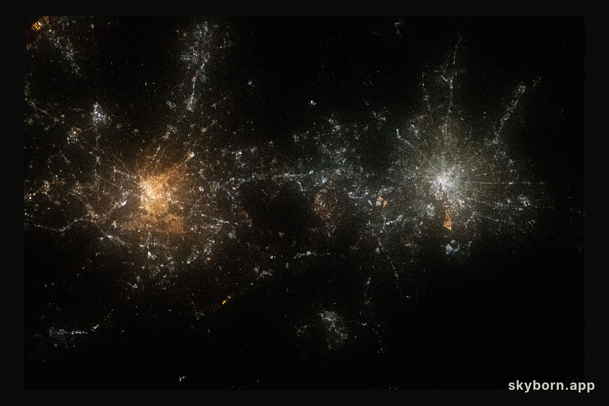 Like two galaxies nearing each other, this nighttime shot from the International Space Station shows the well-lit