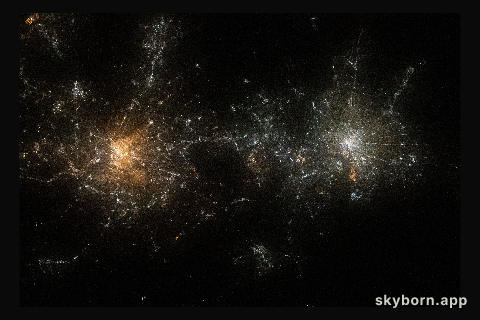 Like two galaxies nearing each other, this nighttime shot from the International Space Station shows the well-lit