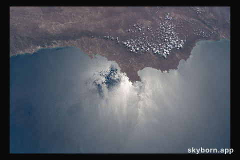 The coast of Chubut Province in Argentina, with the Sun's glint beaming off the Golfo San Jorge and Bahia Camarones, is