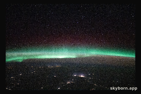 A starry night sky and an aurora are pictured above Russia, in between Ukraine and Kazakhstan, as the International