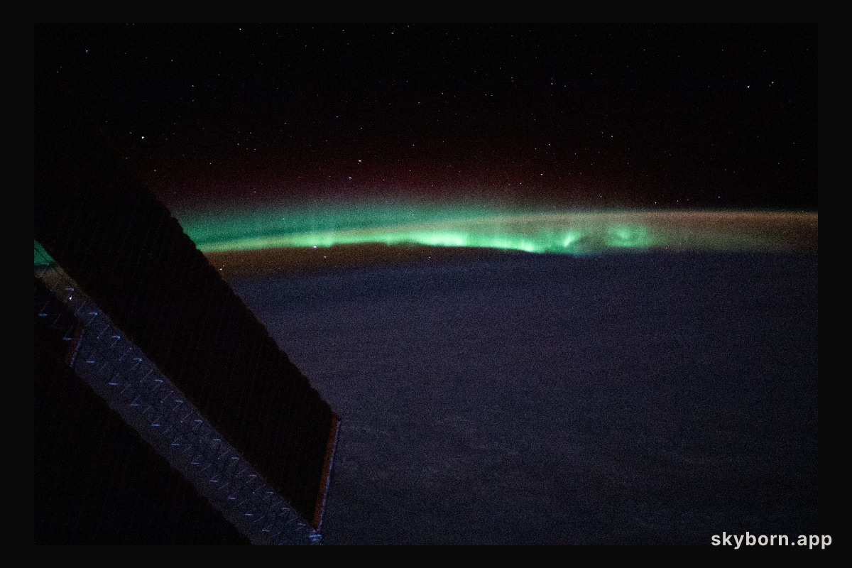 Earth's atmospheric glow and the aurora blanket the horizon as the International Space Station orbited 263 miles