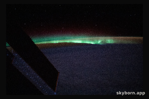 Earth's atmospheric glow and the aurora blanket the horizon as the International Space Station orbited 263 miles