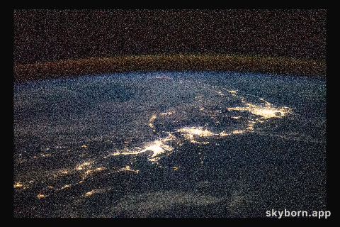 The city lights of Japan, blanketed by the air glow above Earth's horizon, are pictured from International Space