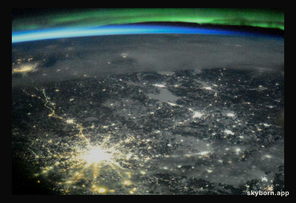 The night lights of Moscow, Russia, are accented by an orbital sunset and an aurora as the International Space Station