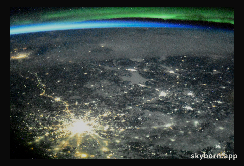 The night lights of Moscow, Russia, are accented by an orbital sunset and an aurora as the International Space Station