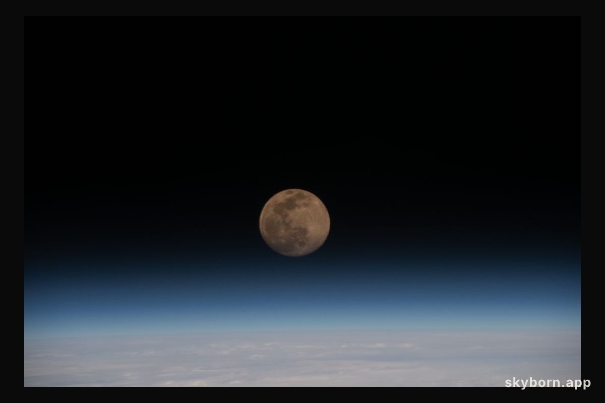 A Full Moon is pictured above the Earth's horizon as the International Space Station orbited 262 miles above Iran
