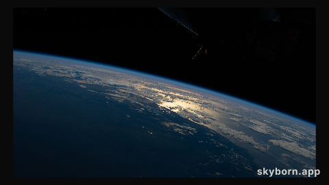 The sun's glint beams off the Tasman Sea on the southeastern coast of New South Wales, Australia, as the International