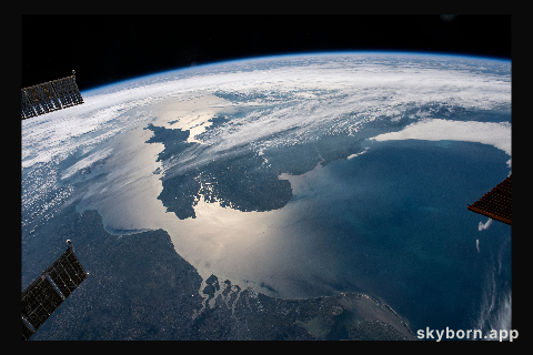 The sun's glint beams across the English Channel and the North Sea in between southern England and the coasts
