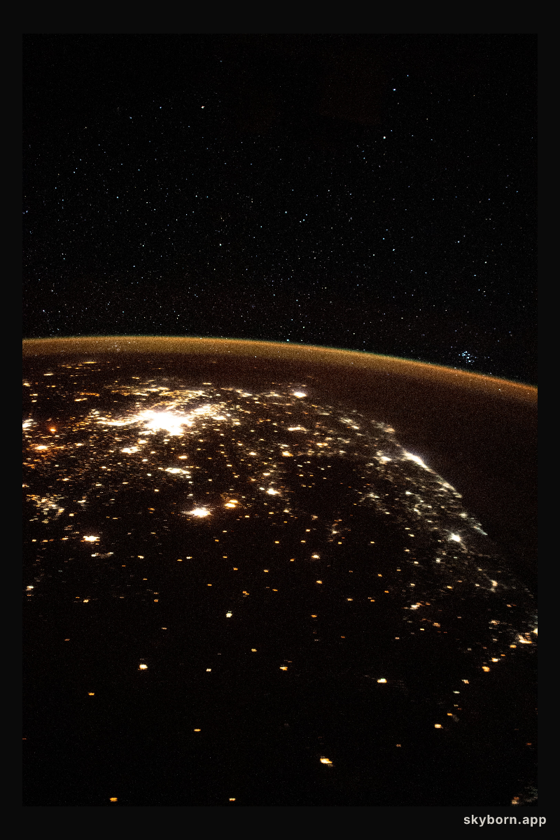 The night lights of South Africa are blanketed by Earth's atmospheric glow and a starry night sky as the International