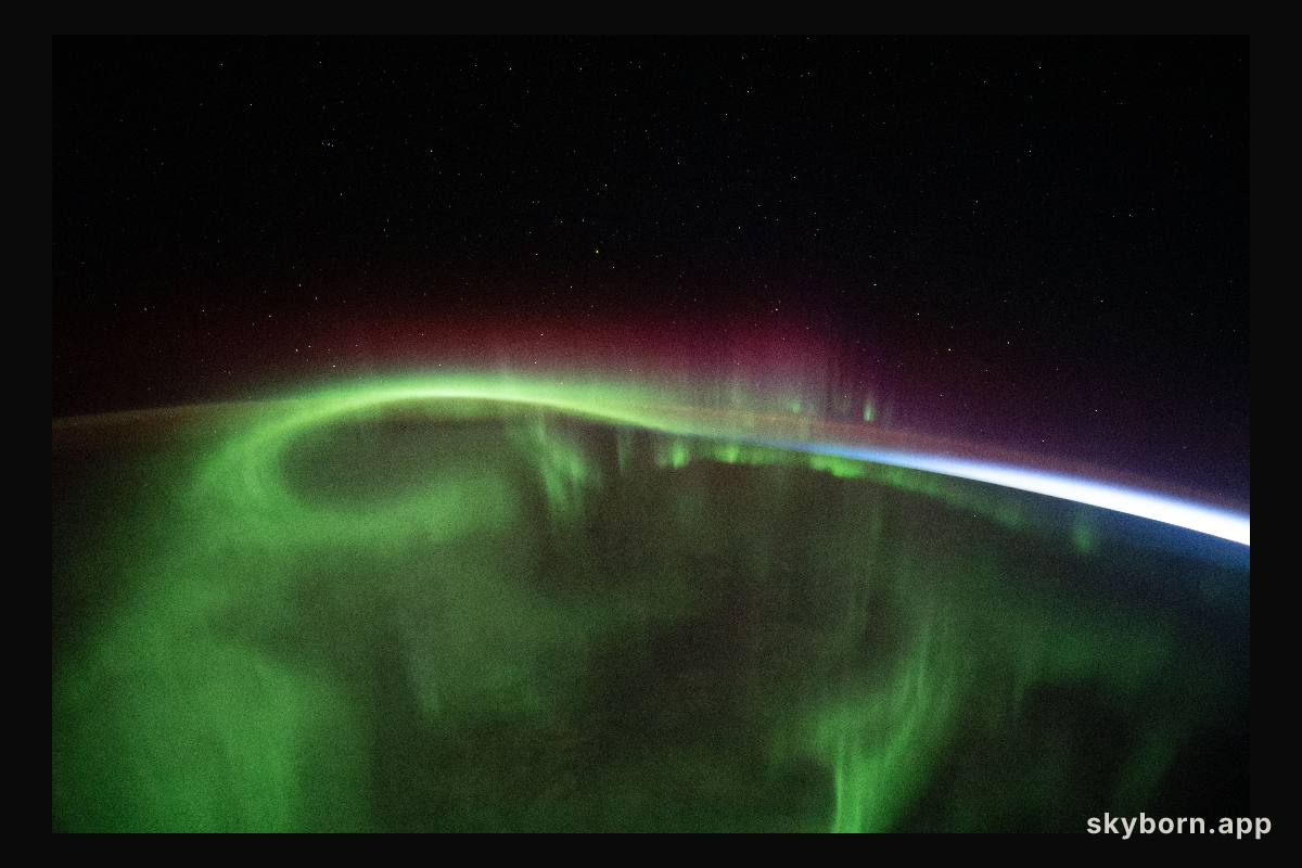 A aurora vividly streams over the Earth as the International Space Station orbited 273 miles above the southern Indian