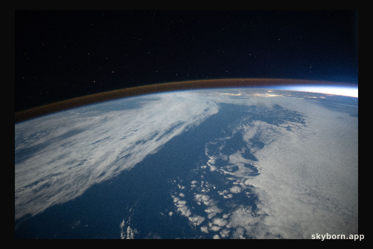 The airglow blankets the Earth's horizon during an orbital sunset in this photograph from the International Space