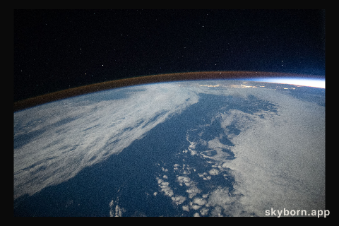 The airglow blankets the Earth's horizon during an orbital sunset in this photograph from the International Space