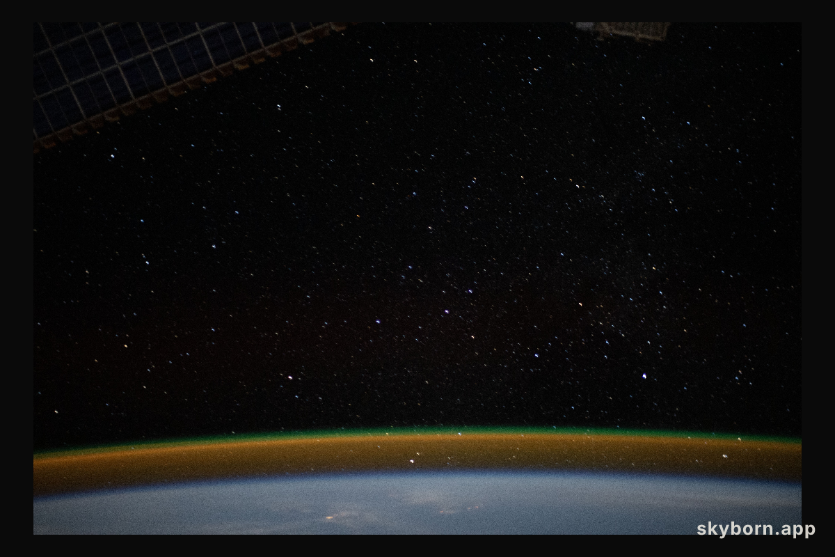 The airglow blankets the Earth's horizon beneath a starry sky in this photograph from the International Space Station