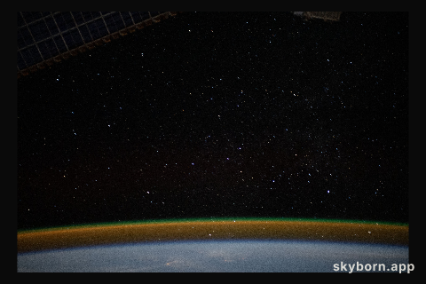 The airglow blankets the Earth's horizon beneath a starry sky in this photograph from the International Space Station