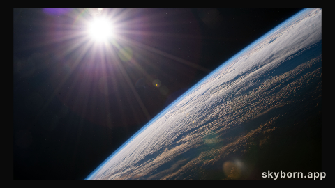 The sun shines above the Earth's horizon as the International Space Station orbited 264 miles above the Canadian