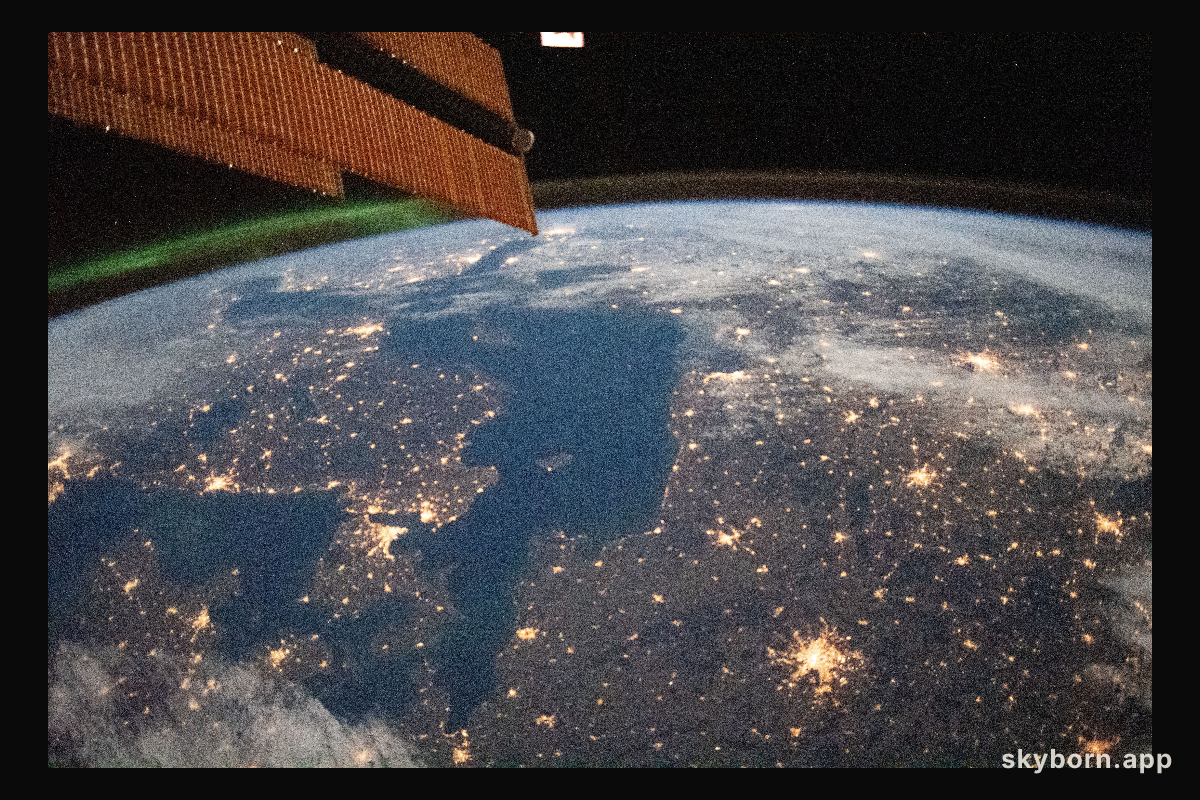 A faint aurora and the Earth's atmospheric glow crown this night time photograph of Northern Europe,