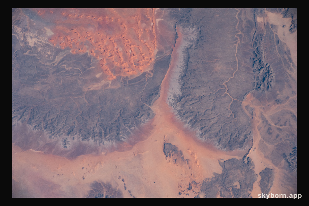 A portion of the Sahara Desert in Algeria, with sand dunes, rocky platforms and sandstone plateaus, is pictured