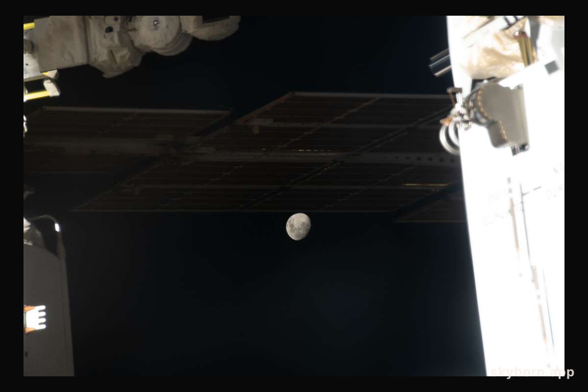 The Moon, with Earth's shadow draping across it during a lunar eclipse, is pictured in a gap in between International