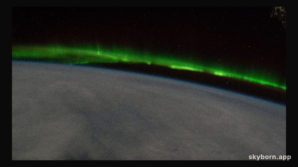 An aurora streams above a cloudy Earth as the International Space Station orbited 268 miles above the south Pacific