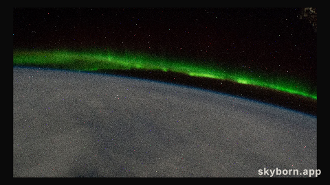 An aurora streams above a cloudy Earth as the International Space Station orbited 268 miles above the south Pacific