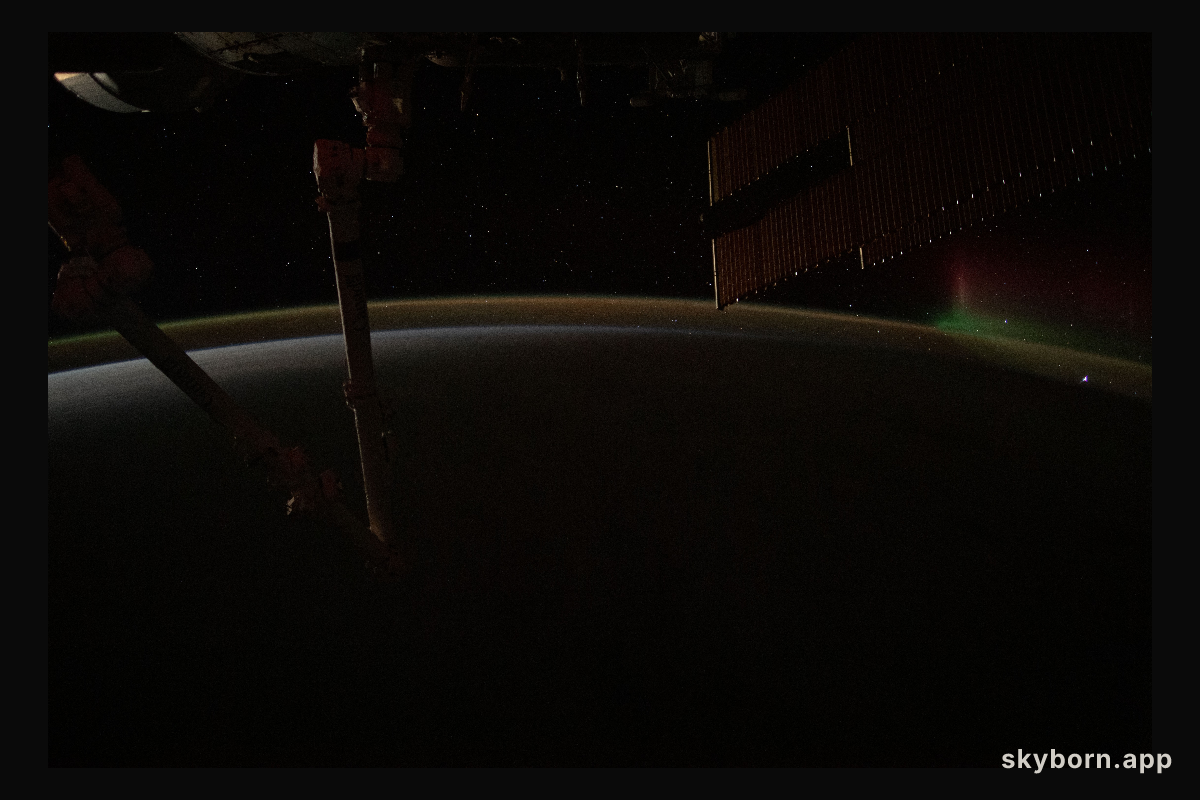 A wispy aurora fades away above Earth's atmospheric glow as the International Space Station orbits into a sunrise 271