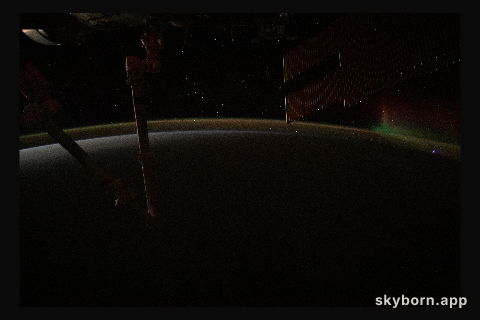 A wispy aurora fades away above Earth's atmospheric glow as the International Space Station orbits into a sunrise 271