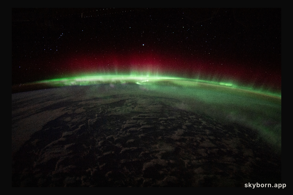 An aurora crowns the Earth beneath a starry sky in this night time photograph from the International Space Station