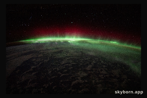 An aurora crowns the Earth beneath a starry sky in this night time photograph from the International Space Station