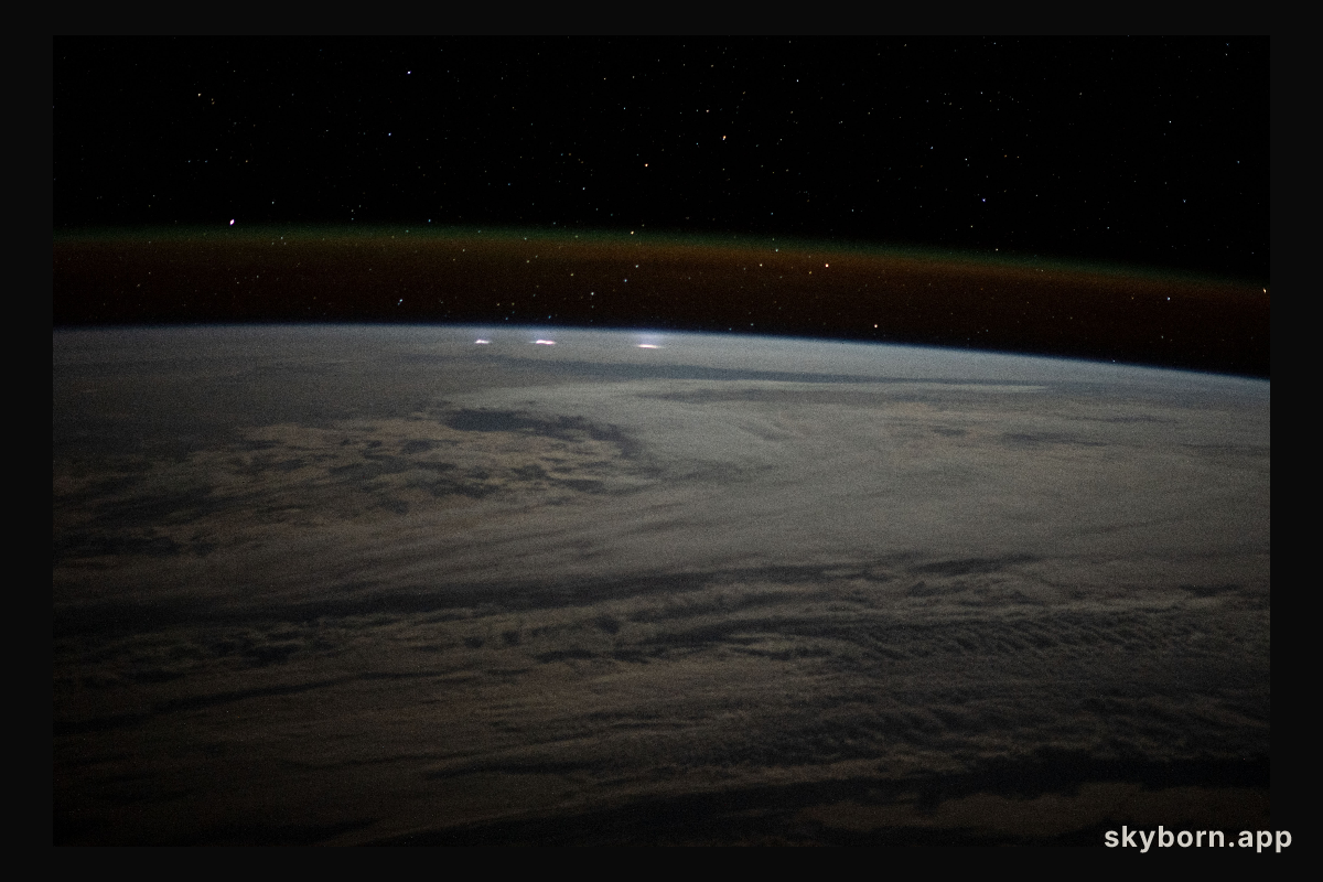 A cloudy, south Indian Ocean between Africa and Antarctica, with lightning storms near the horizon beneath