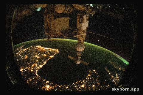 This night time photograph of the coastal city lights of Portugal, Spain, and France, with the Bay of Biscay